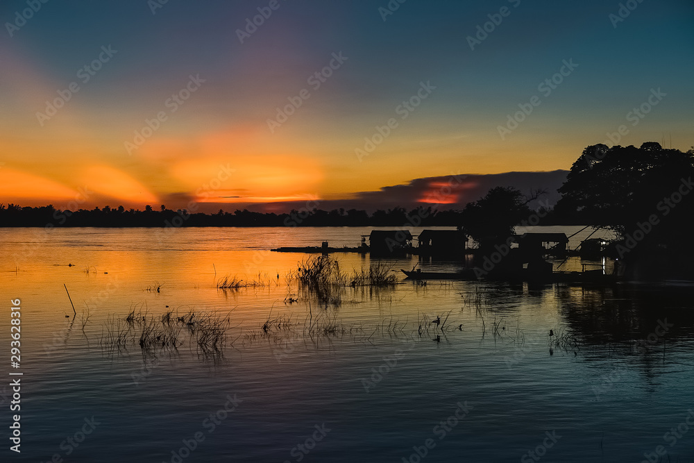 Fototapeta premium fisherman in a magical sunset in mekong river