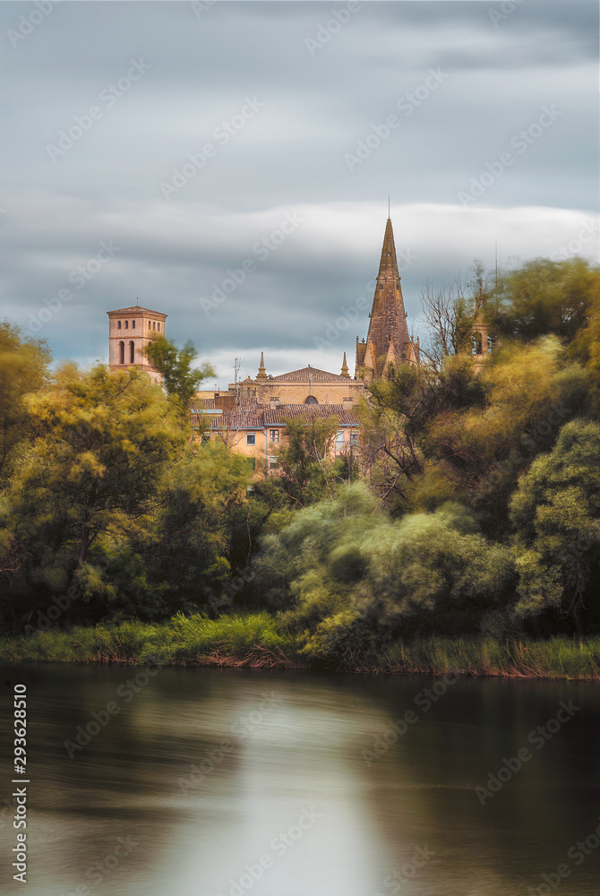 river and the wind in the trees with a church on the background