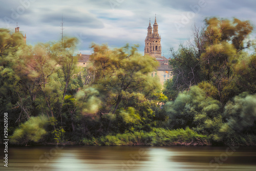 river and the wind in the trees with a church on the background