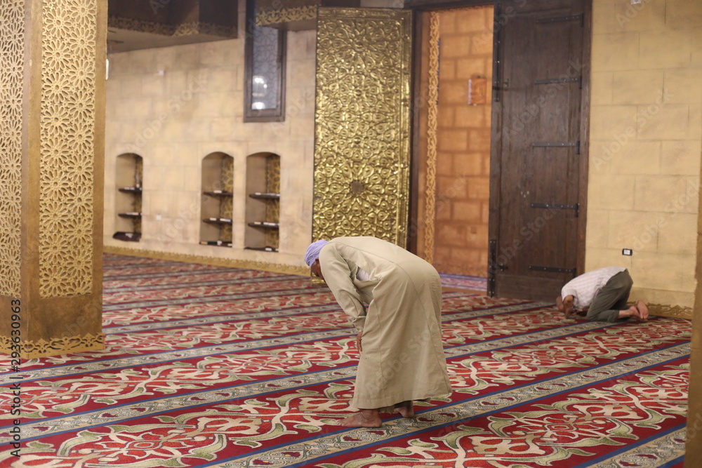 monk in temple. interior of the Mosque Masjid El-Fateh. Colorful Mosque Masjid alsahaba Sharm El Sheikh in old town monk in temple. interior of the Mosque Masjid El-Fateh. Colorful Mosque Masjid alsahaba Sharm El Sheikh in old town