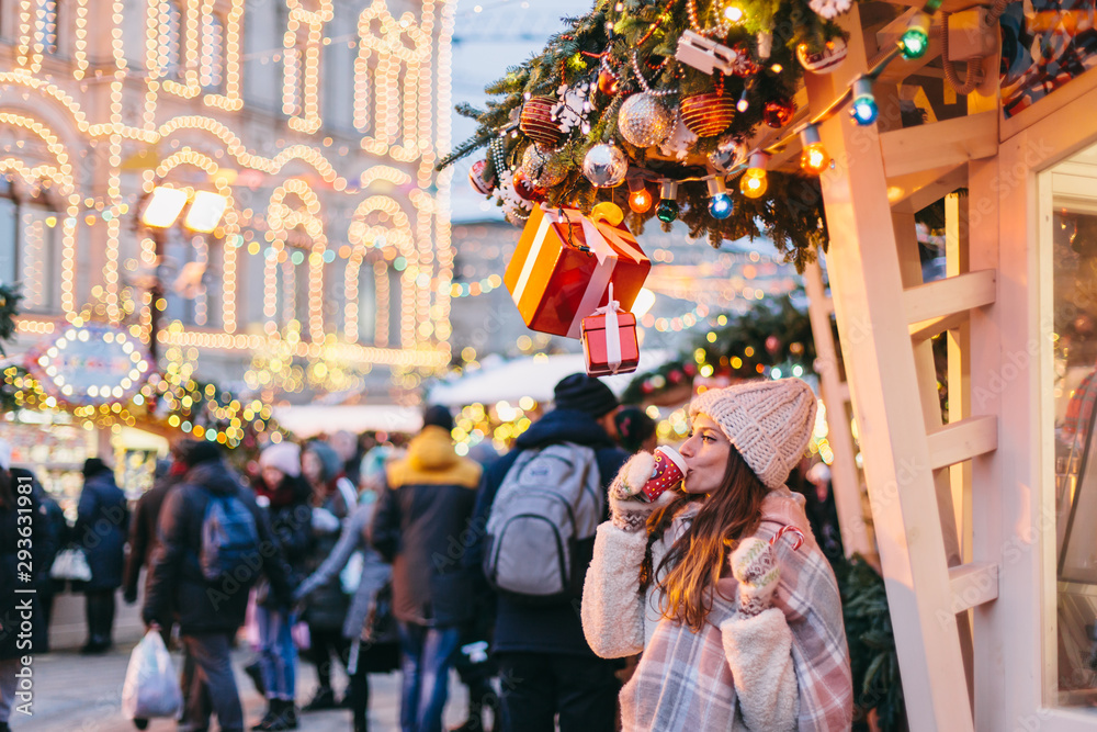 Girl walking on Christmas Market on Red Square in Moscow