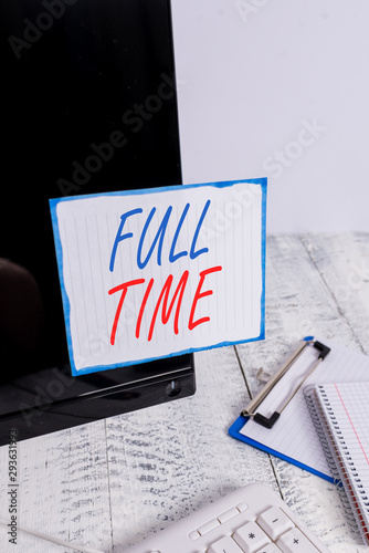 Writing note showing Full Time. Business concept for working or operating the customary number of hours in a day Note paper taped to black computer screen near keyboard and stationary photo