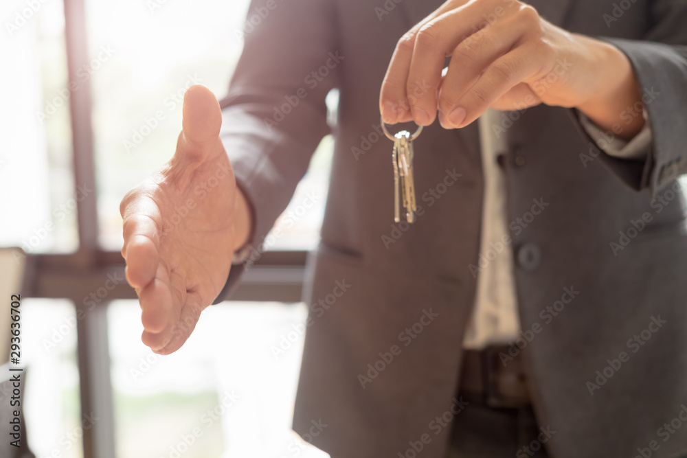 Obraz premium real estate agent shaking hands to his client after signing contract agreement in office,concept for real estate, moving home or renting property