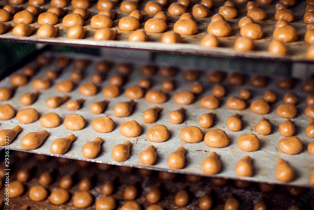 A process of production bakery products at the factory. Sweet cake on the production line at the bakery A process of production bakery products at the factory. Sweet cake on the production line at the bakery