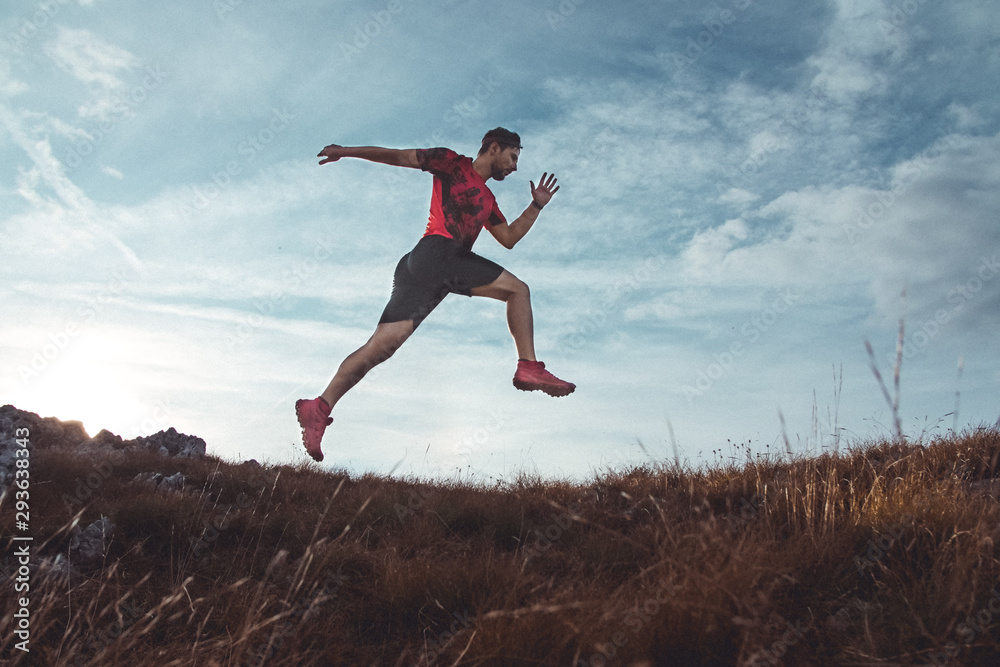 Trail running in the mountains. Young male athlete preparing for race Trail running in the mountains. Young male athlete preparing for race