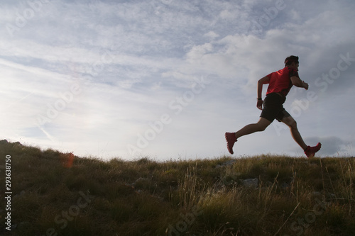 Trail running man jumping in the sky