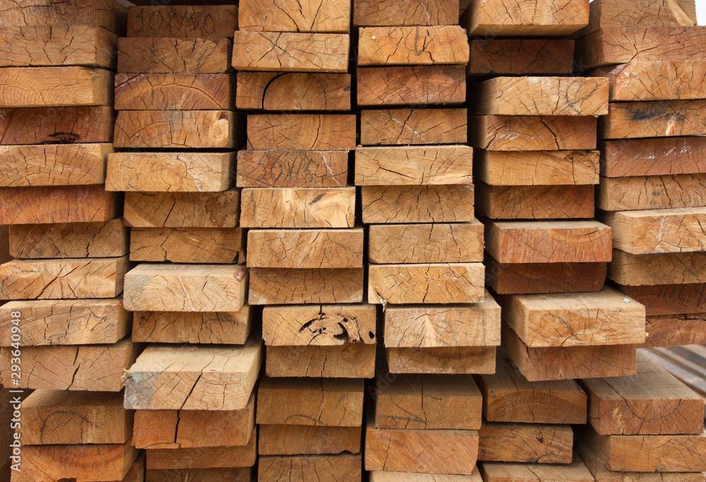 Lumber warehouse. Wooden boards are stacked. Wood texture, background Lumber warehouse. Wooden boards are stacked. Wood texture, background
