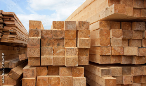 Lumber warehouse. Wood planks and timber stacked in stacks outdoors photo