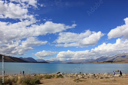 Lake Tekapo on a sunny day with a few fair-weather clouds