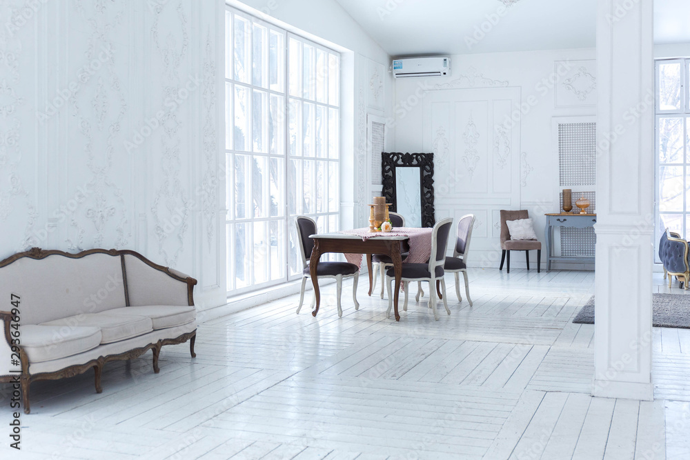 Fototapeta premium A spacious bright living room with a stylish modern design with elements of antique decor and beautiful chic furniture