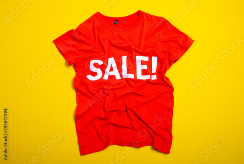 Shirt sale fashion on yellow background, top view