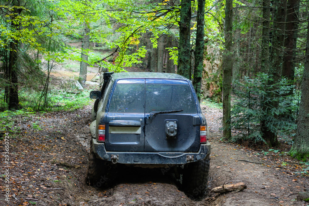 Offroad car in the swamp in the mountains. Carpathians. Wheels Offroad car in the swamp in the mountains. Carpathians. Wheels
