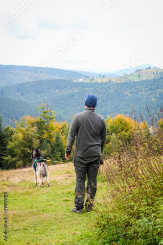 .A man with a Husky dog ​​in the Carpathian Mountains.