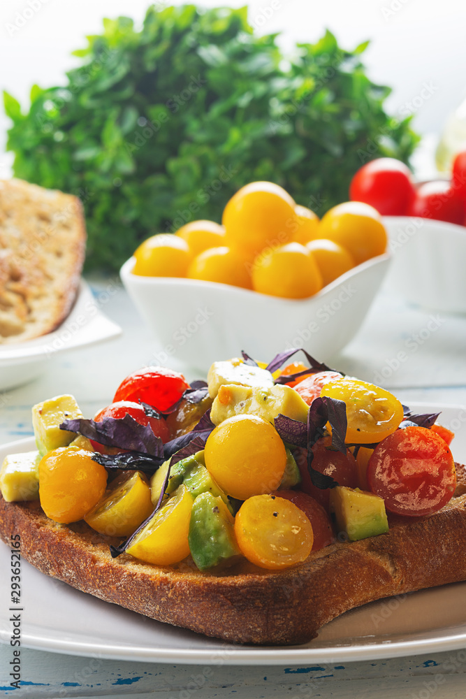 Bruschetta with avocado, tomatoes and basil with balsam sauce. Close up. Selective focus. Bruschetta with avocado, tomatoes and basil with balsam sauce. Close up. Selective focus.