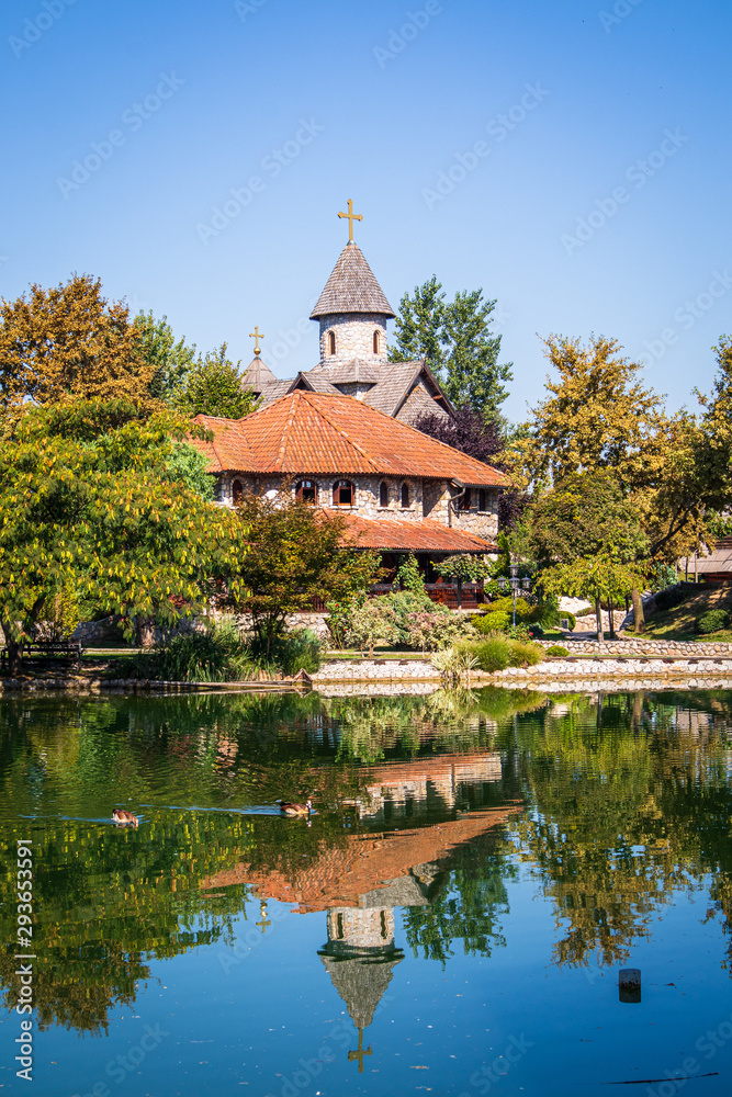 Beautiful vintage buildings by the small lake in ethno village Stanisici in Bosnia and Herzegovina