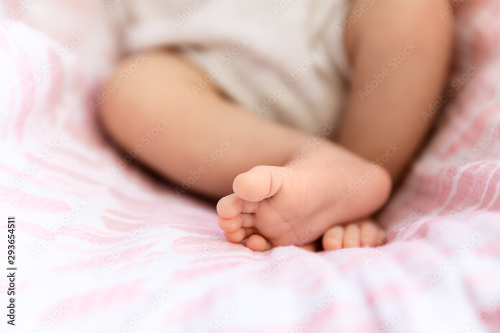 Closeup of newborn feet, tiny toes in selective focus Closeup of newborn feet, tiny toes in selective focus