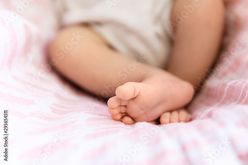 Closeup of newborn feet, tiny toes in selective focus