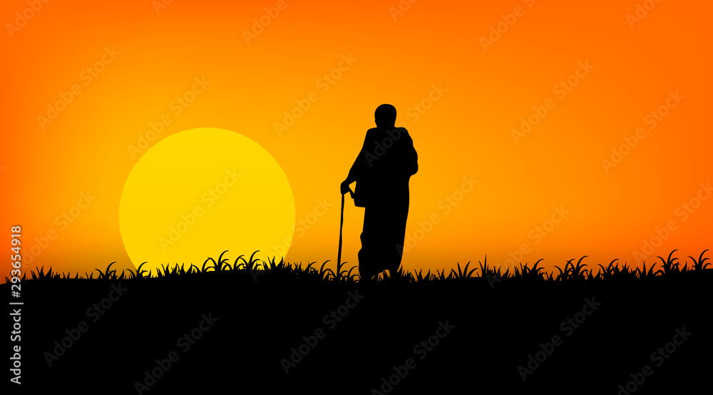 Indian monk with a cane on a sunset background. Indian sage. Silhouette of a monk.