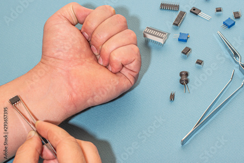 A chip is installed in the hand of a young man to track the location of people.