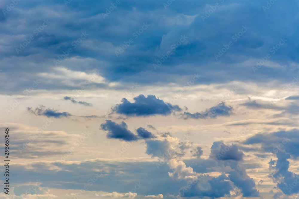 Blue curly clouds in the evening sky_ Blue curly clouds in the evening sky_