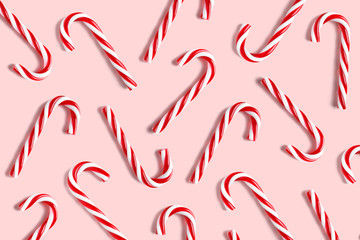 Candy cane for party design on pink background.