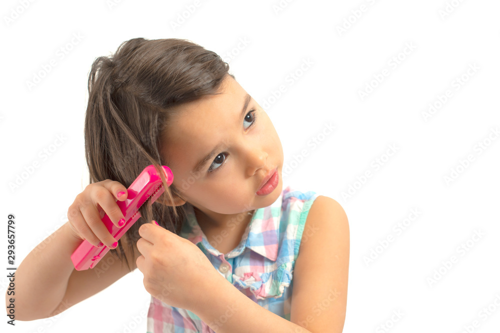 little girl with the Hair Straightener doing her hair little girl with the Hair Straightener doing her hair