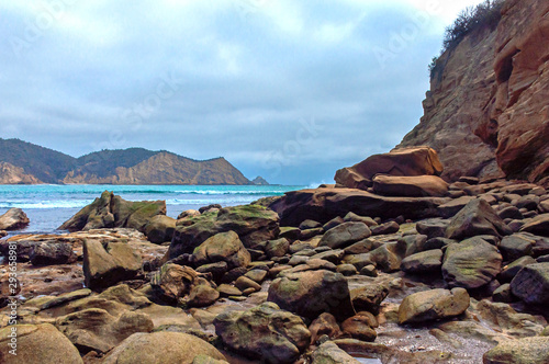 Rocks of all sizes with the ocean and sky in the background, on an overcast day, at the Los Frailes Beach National Park, Manabi, Ecuador