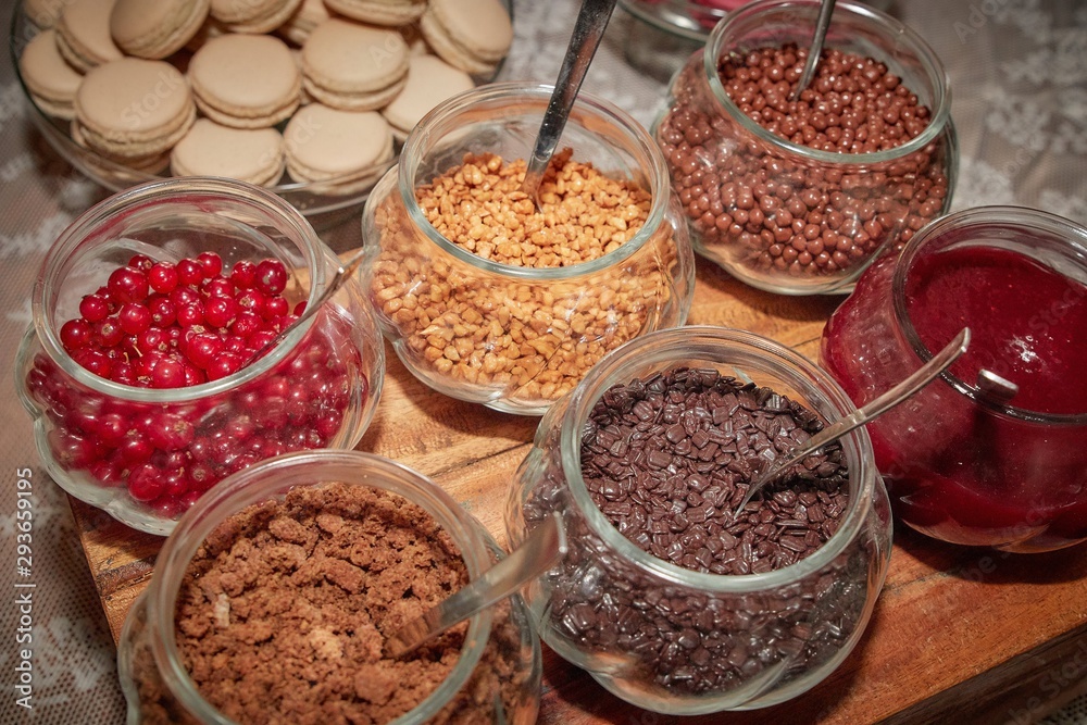 Jars with cereal chips, chocolate, cookies and jam.
