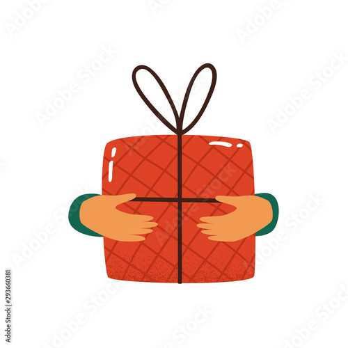 Human hands hold red gift box wrapped and decorated with bow isolated on white background. Festive concept of merry Christmas, happy new year, birthday.