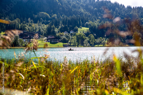Fototapeta Naklejka Na Ścianę i Meble -  The mountain lake Thiersee in Tyrol, Austria. Boat with Fisherman on lake.