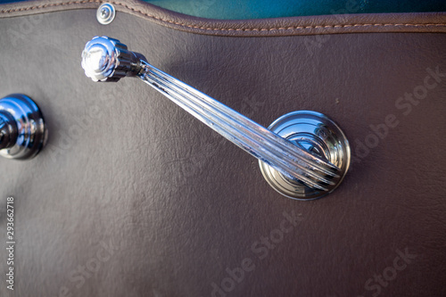 Retro window crank of a classic car.