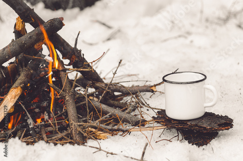 Wallpaper Mural Walking mug with coffee near the campfire. Concept hike, walk, trip in winter Torontodigital.ca