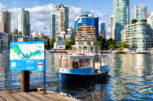 Vancouver, Canada little ferry boats carry passengers across False Creek. Close up with city in the background photo