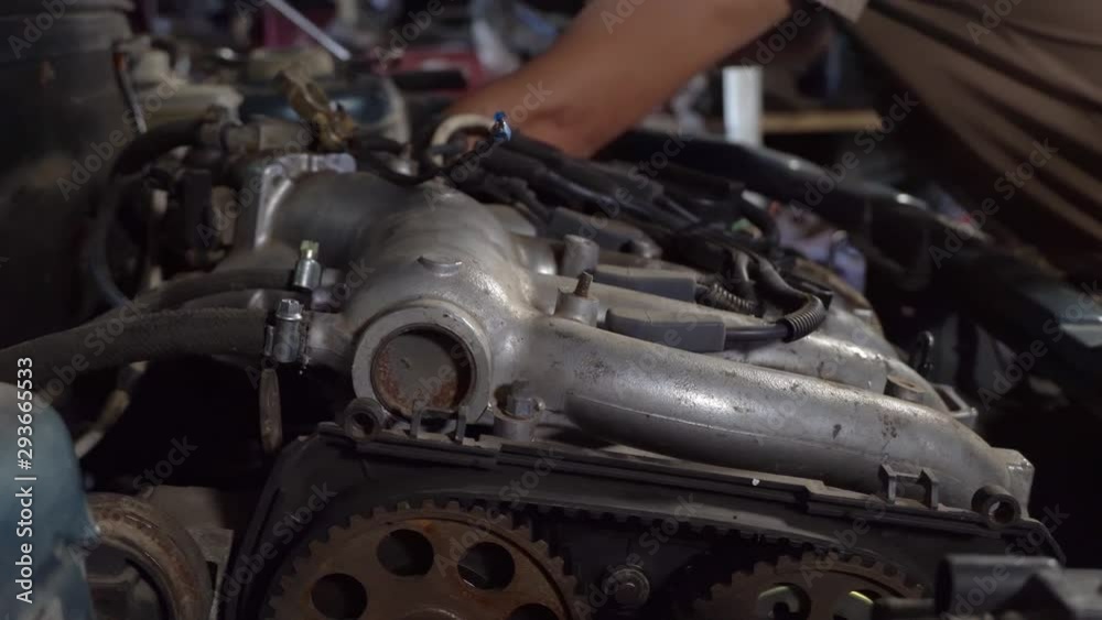 Auto mechanic working on car engine in mechanics garage. close-up shot Auto mechanic working on car engine in mechanics garage. close-up shot
