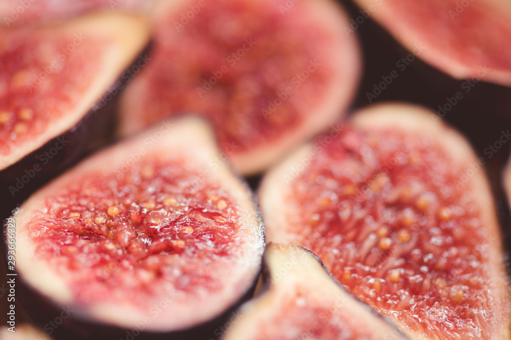 Fresh sliced figs on table closeup. Top view. Selective focus. Fresh sliced figs on table closeup. Top view. Selective focus.