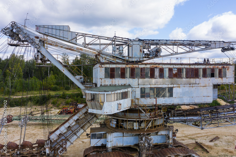 old rusty multi bucket excavator, giant stacker, absetzer in sandy career