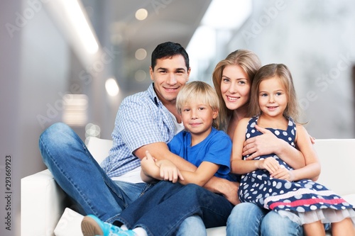 Young  family at home smiling at camera
