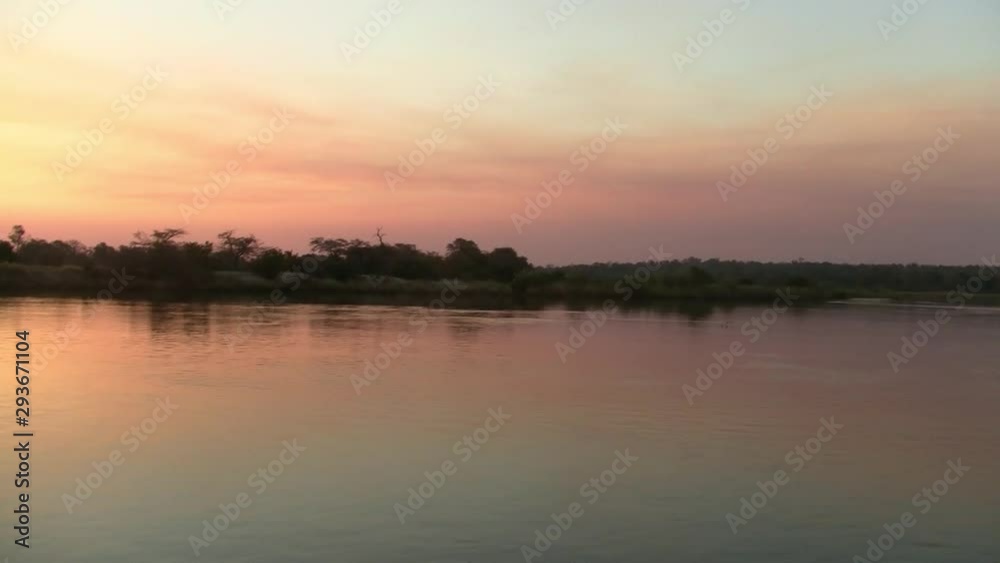 Romantic, Calm, Orange Sunset on the Okavango River, Namibia, Africa Romantic, Calm, Orange Sunset on the Okavango River, Namibia, Africa