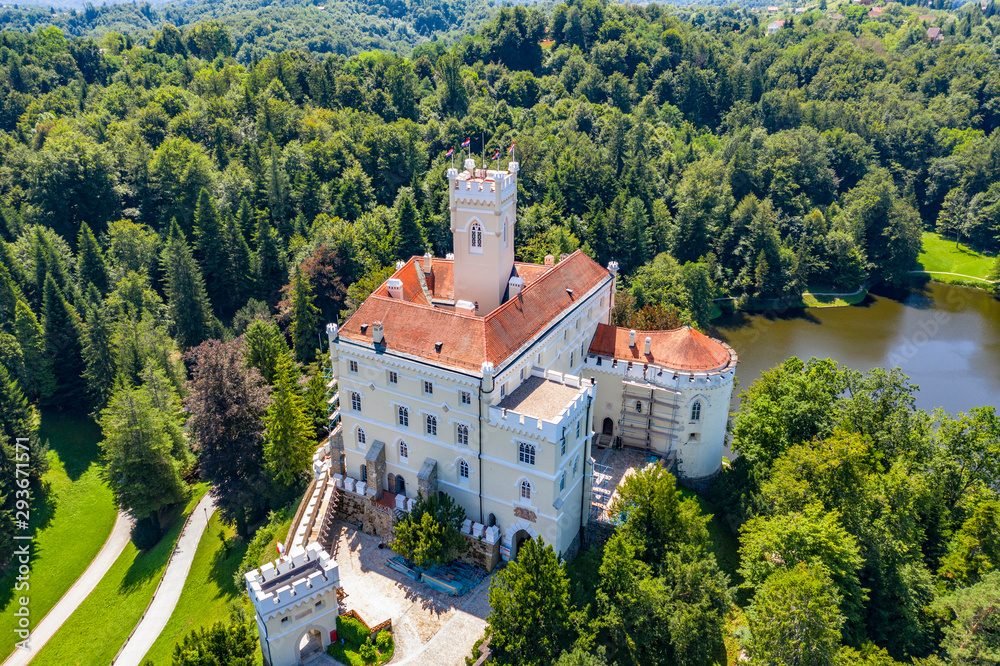 Obraz premium Aerial view of old castle of Trakoscan on lake in green wood in Zagorje, Croatia on sunny summer day