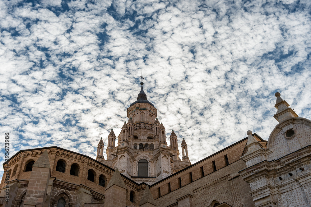 Exterior view of Tarazona Cathedral (Spain) with a dramatic sky of clouds.