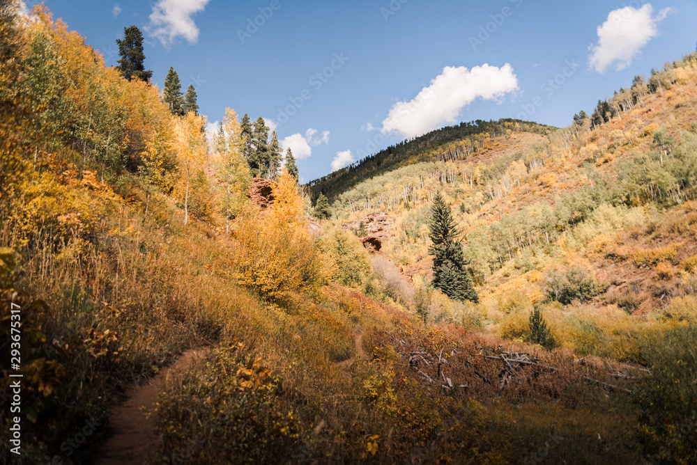 Landscape view of the mountains in Vail, Colorado covered in fall foliage. 