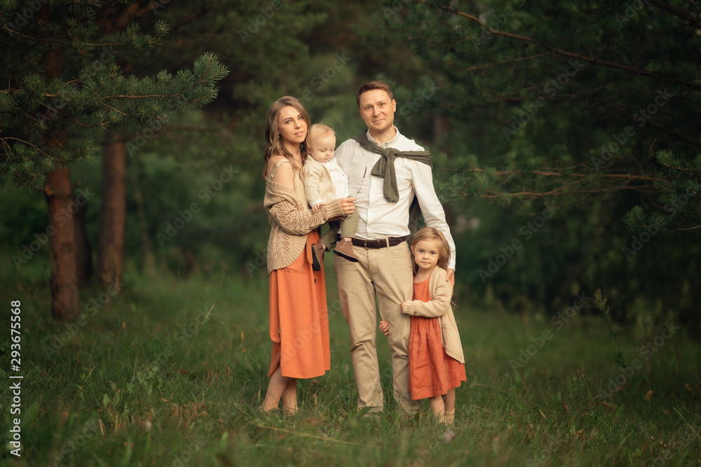 father, mother, daughter and son standing in the forest, Full Length shot father, mother, daughter and son standing in the forest, Full Length shot