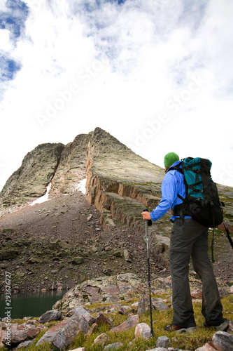 Hiker looking up at Mt. Vestal and Wham Ridge while backpacking the Grenadier Range near Silverton, Colorado.     photo
