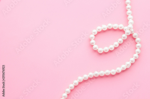 Pearls on pastel pink background