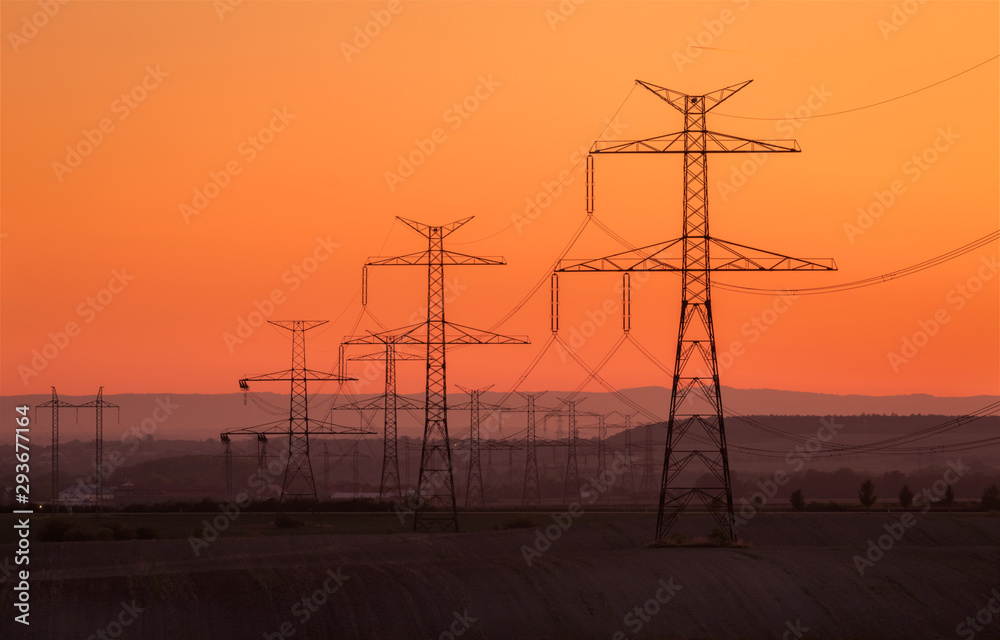 Silhouette electricity pole, electricity pylons technology on sunset time background, Ceske Stredohori, Czechia