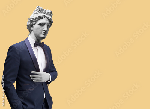 Modern art collage. Concept portrait of handsome stylish man in elegant blue suit .Gypsum head of of Apollo. Man in suit.