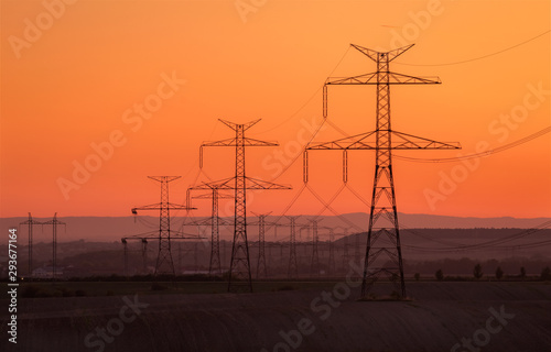 Obraz na płótnie Silhouette electricity pole, electricity pylons technology on sunset time background, Ceske Stredohori, Czechia w salonie