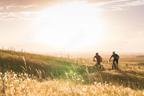 Two friends mountain biking at the Erie Singletrack Trails in beautiful evening light, Colorado. photo