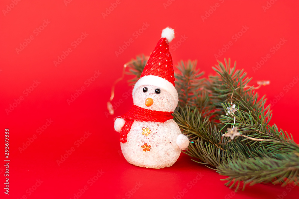Snowman and fir branch on a red background. Christmas background Snowman and fir branch on a red background. Christmas background