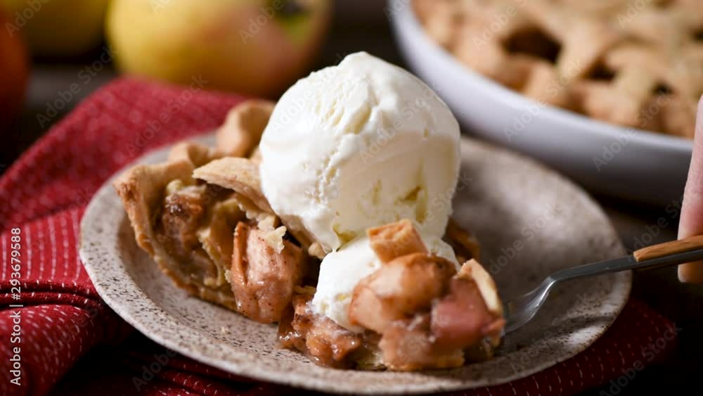 Traditional american apple pie with ice cream. Take a bite of pie with fork. Eating apple pie Traditional american apple pie with ice cream. Take a bite of pie with fork. Eating apple pie